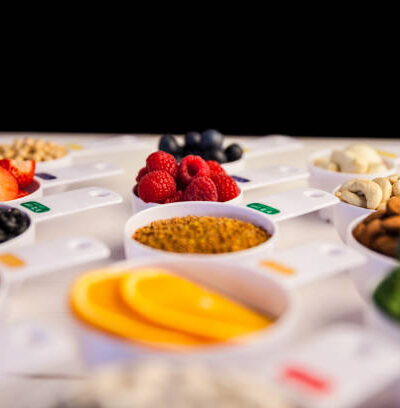 Portion cups of healthy ingredients on wooden table